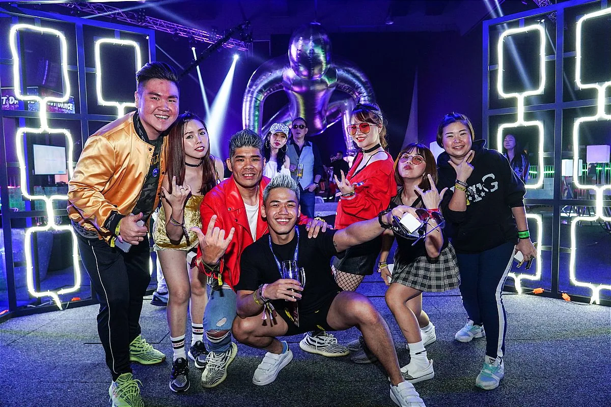 A group of individuals poses for a photo in front of a large screen at the Herbalife Nutrition Future President’s Team Retreat in Penang organized by Moonman Events sdn bhd