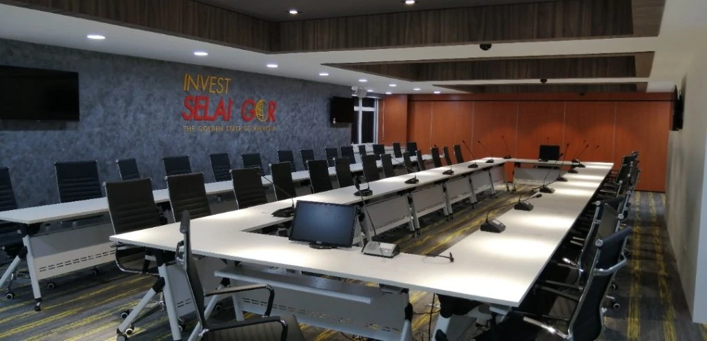 A well-designed conference room with seating and a television, highlighting the renovations made by Moonman Events sdn bhd at the Invest Selangor Office.