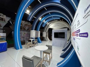 MISC exhibit at IPTC 2023, characterized by expansive blue and white walls where the exhibition booth was designed and fabricated by Moonman Events