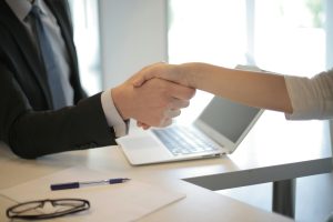 a shot of handshake between a client and an employee of Moonman Events for their next event